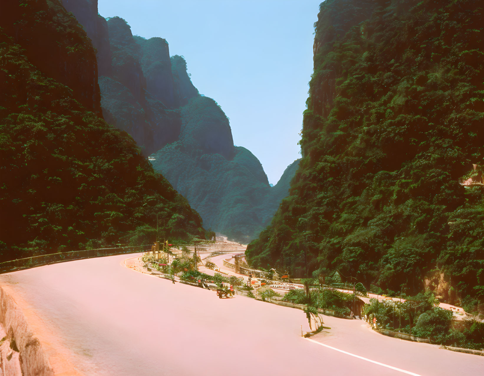 Scenic winding road through lush mountain landscape