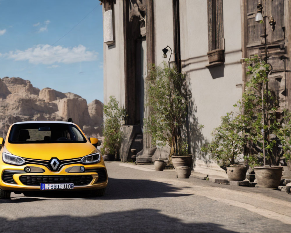 Yellow Renault car parked on cobblestone street with old buildings and rocky hills in background