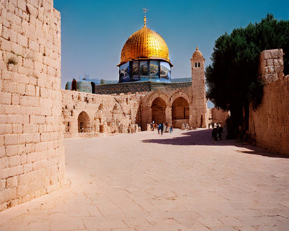 Historic stone walls and golden dome at Dome of the Rock courtyard.