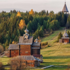 Serene pastoral scene with traditional-style buildings and church spire surrounded by lush greenery