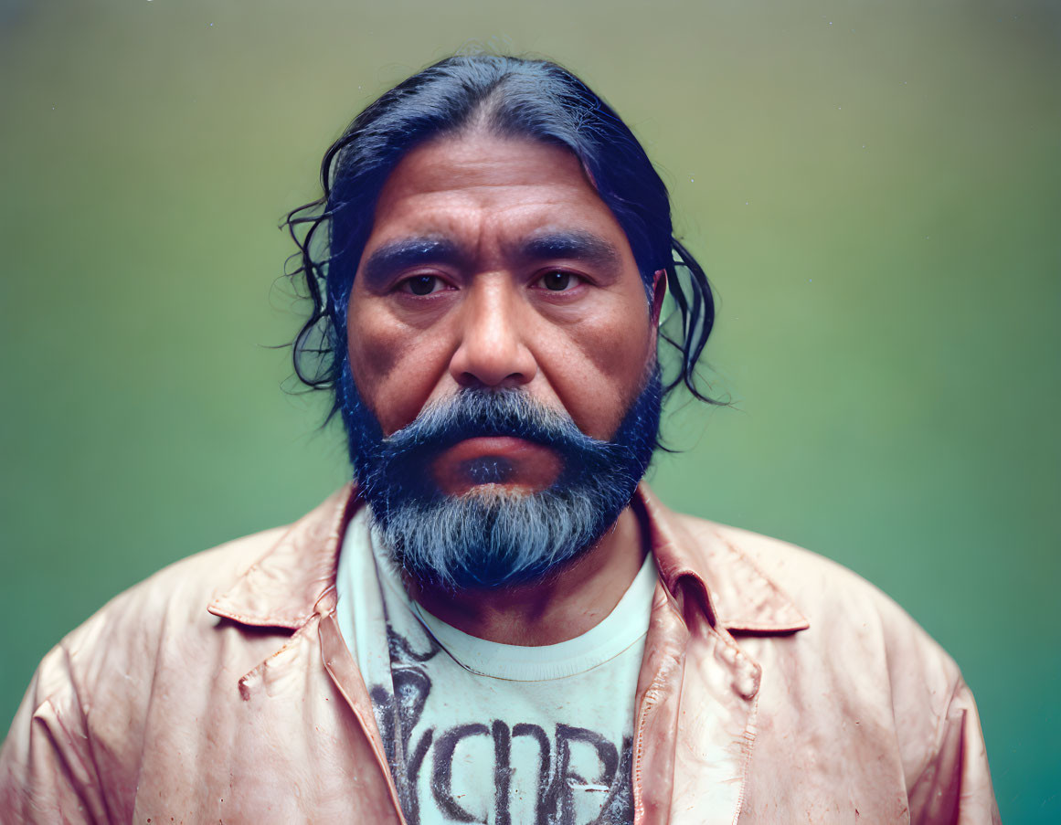 Man with Full Beard and Mustache in Pink Shirt on Green Background