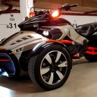 Orange and Black Futuristic Motorcycle with Neon Blue Lighting in Underground Garage