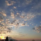 Vibrant hot air balloons in sunset sky above serene landscape