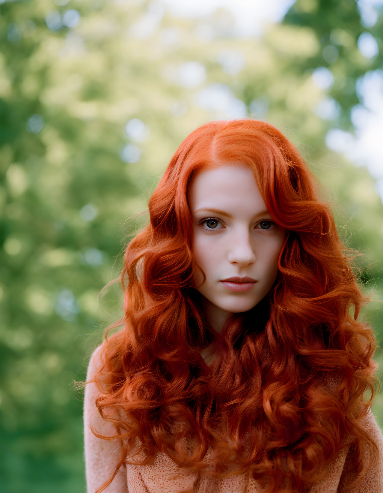 Vibrant Red Hair and Fair Skin Against Blurred Green Background