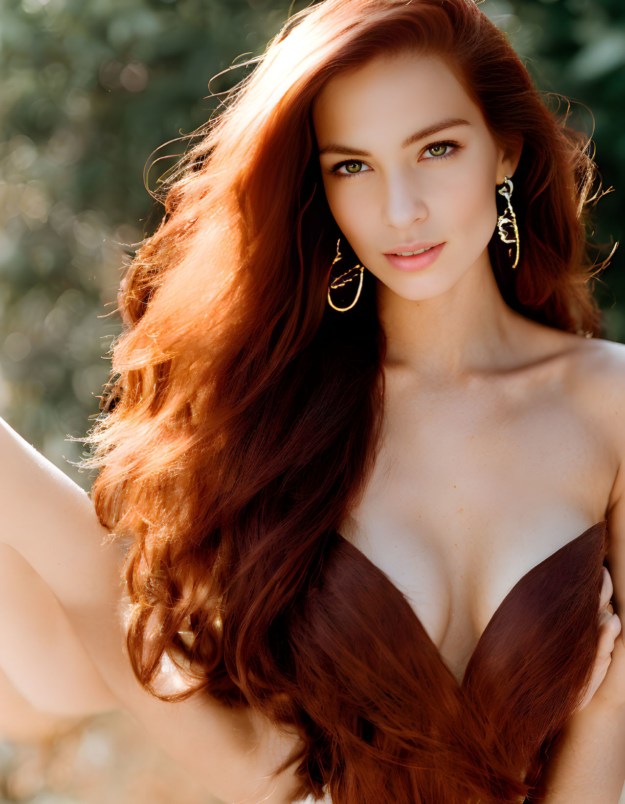 Woman with Long Red Hair and Green Eyes in Brown Top and Gold Earrings against Natural Background