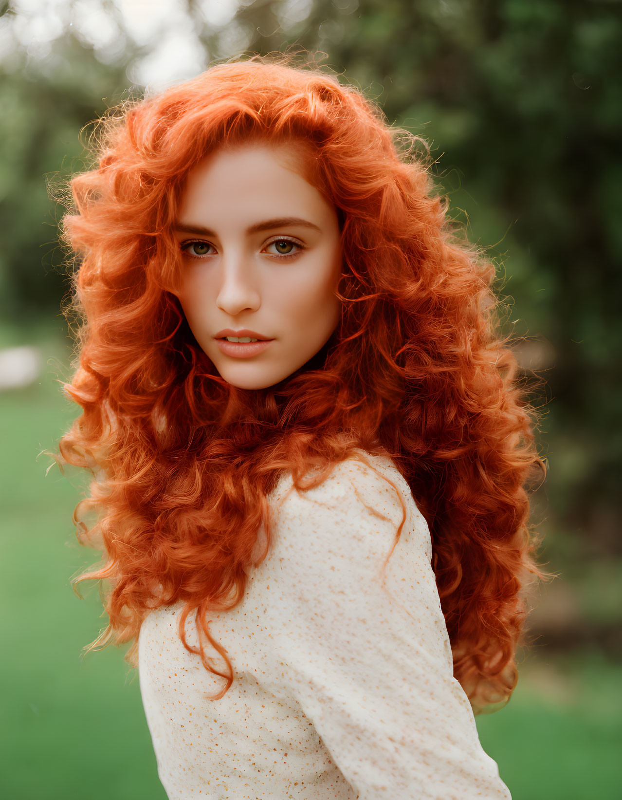 Curly Red-Haired Woman in Blouse on Green Background