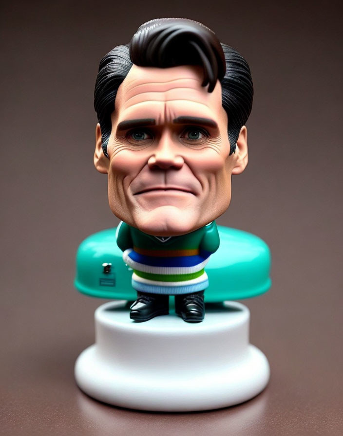 Caricature-style figurine with oversized head, suit, striped tie, and white base