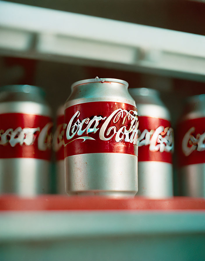 Shelf display of vintage-style Coca-Cola cans