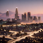 Twilight cityscape with illuminated skyscrapers and car light streaks