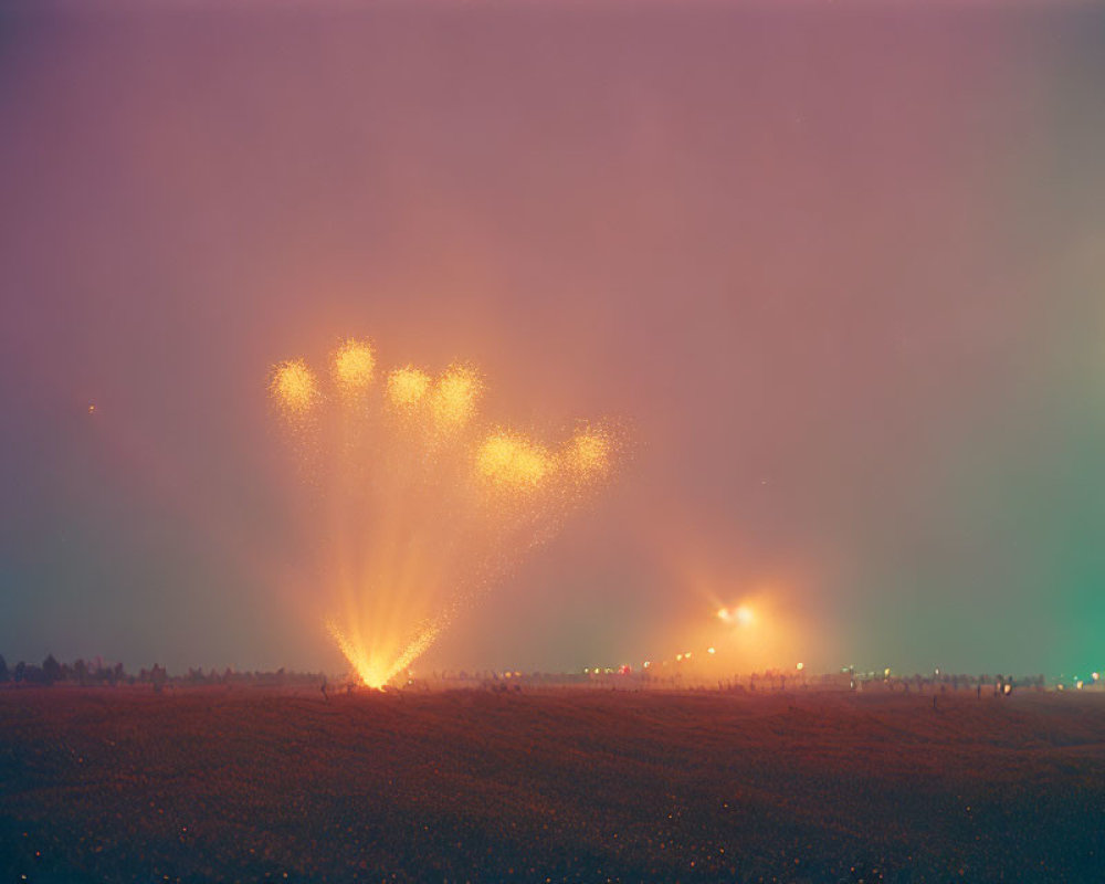 Heart-shaped fireworks illuminate misty night sky with distant observers.