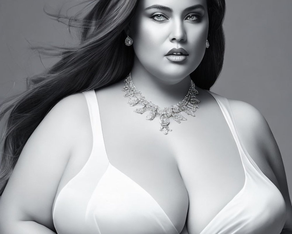 Monochrome portrait of plus-size woman in white attire & intricate jewelry