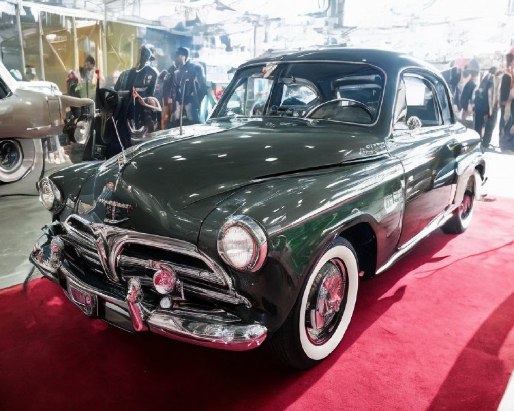 Classic Green Car Displayed at Indoor Car Show with Red Carpet and Classic Cars in Background