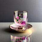 Floral design glass on saucer against gradient background