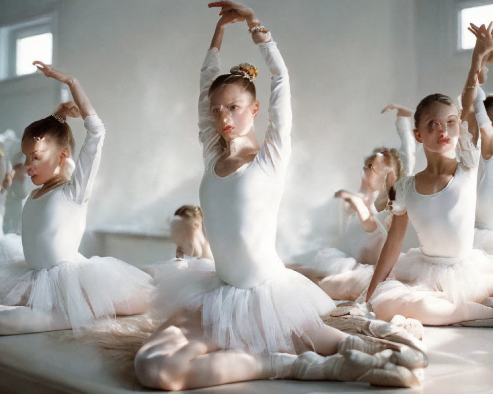 Ballet dancers in white tutus practicing in studio mirror