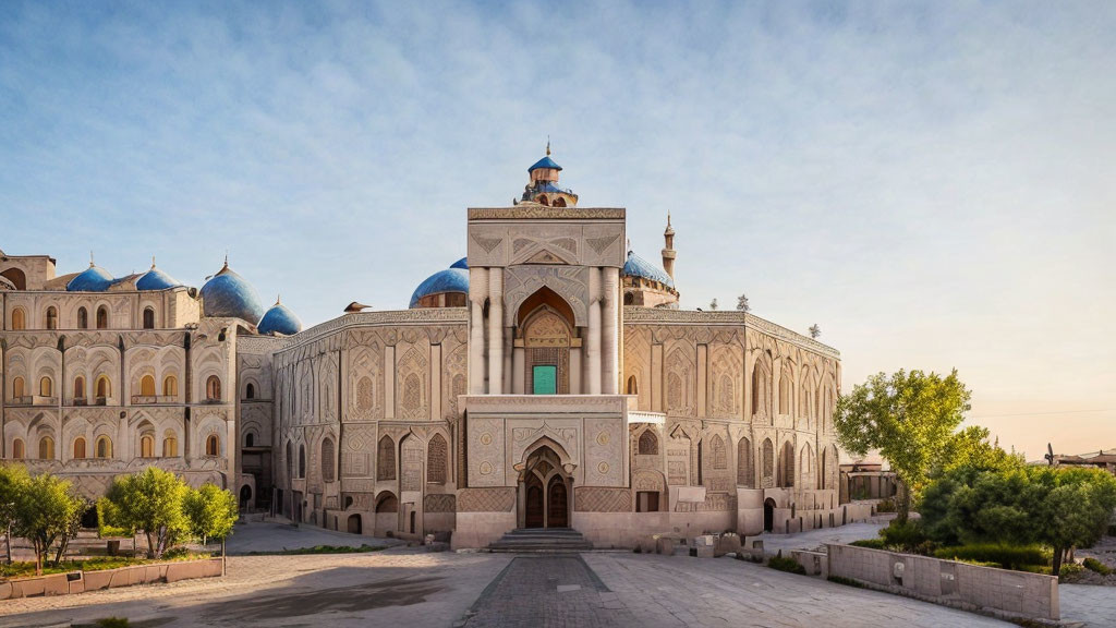 Ancient palace with intricate designs, domes, and arches at sunset.