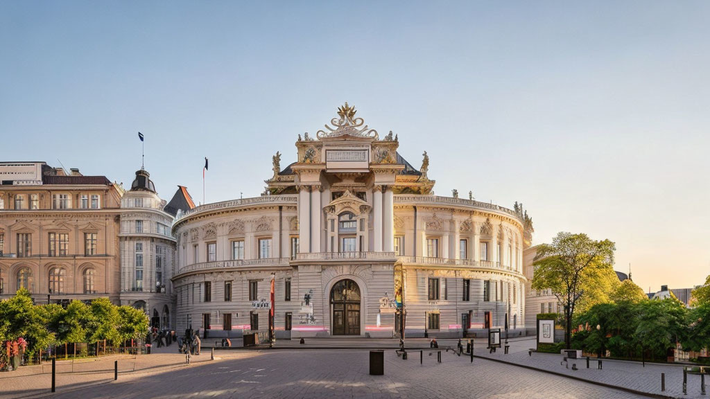 Ornate White Building with Grand Entrance and Sculptures at Twilight