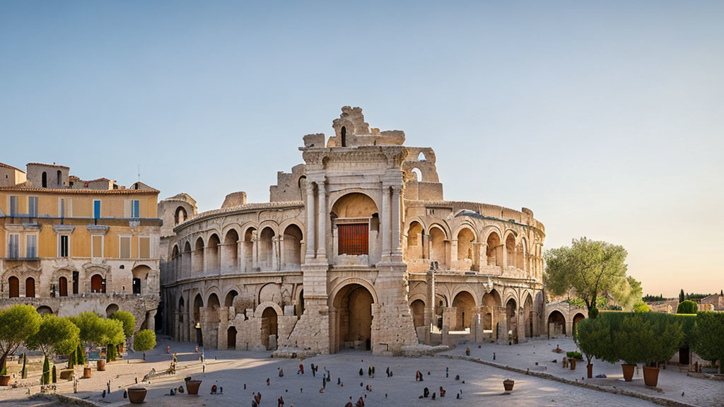 Ancient Roman amphitheater facade with arches in a plaza setting.