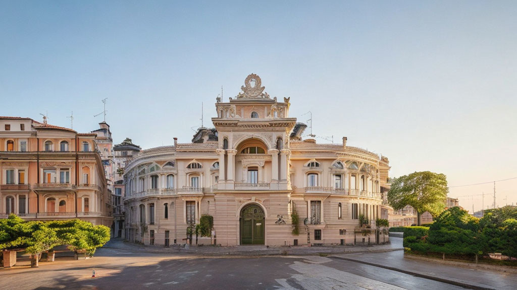 Historical white building with intricate architecture beside classic residential structures under clear sky