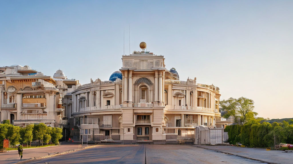 Classical building with central dome and intricate details in warm sunlight