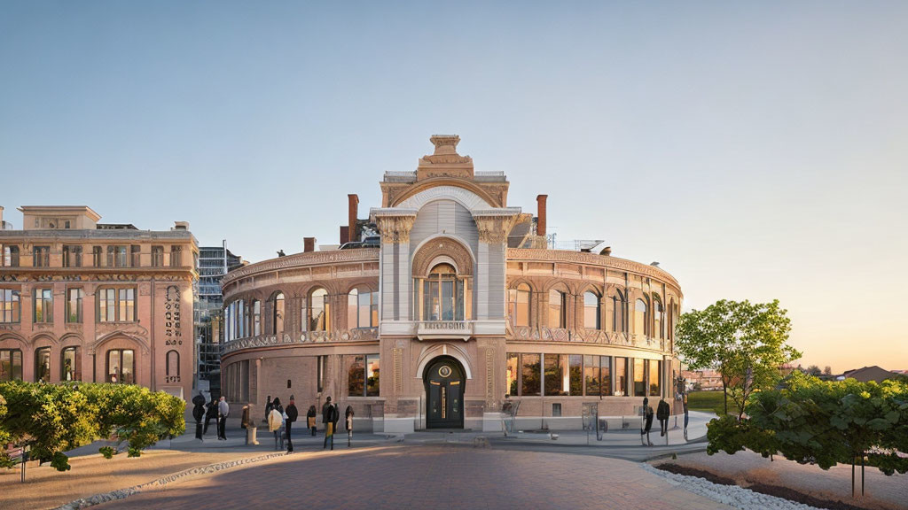 Historical building with arched windows and central entrance in urban setting at dusk