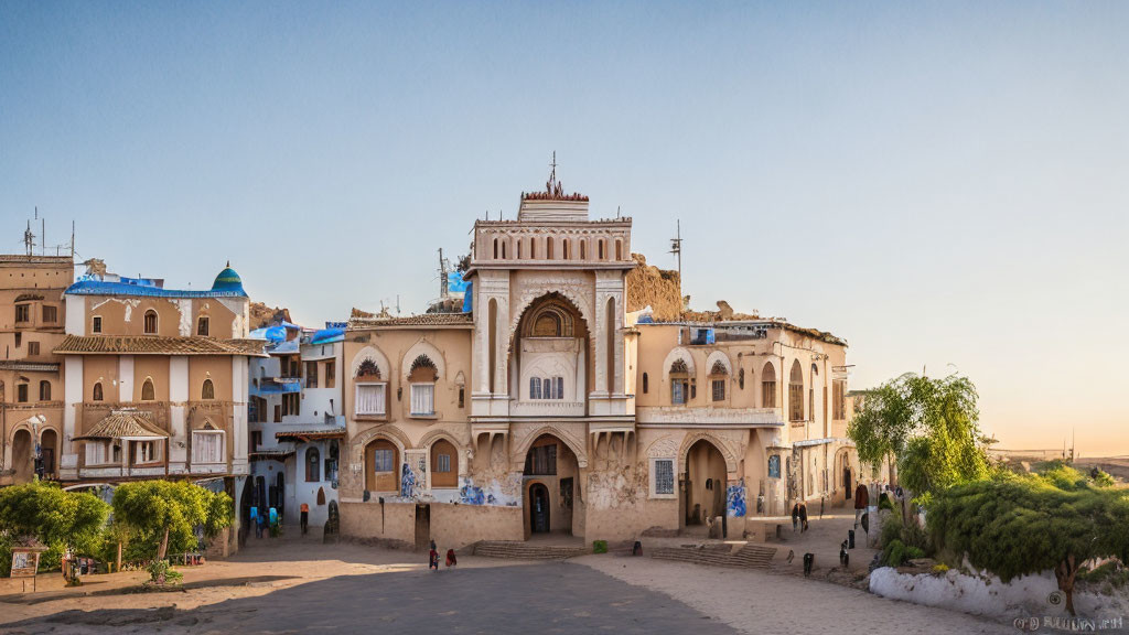 Traditional building with archways and terraces in golden sunlight with people.