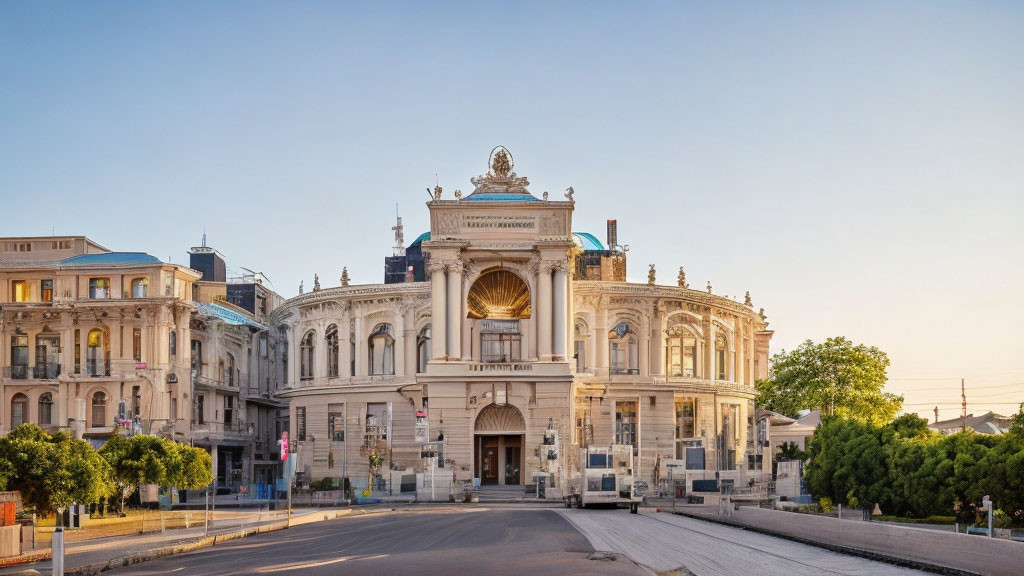 European-style opera house with grand entrance amidst classic architecture at dawn or dusk