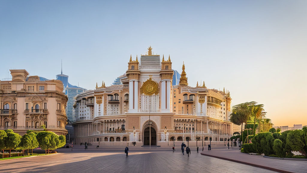 Ornate white building with golden details and clock tower in green plaza