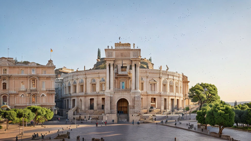 Historical building with archway entrance and symmetrical wings under clear sky