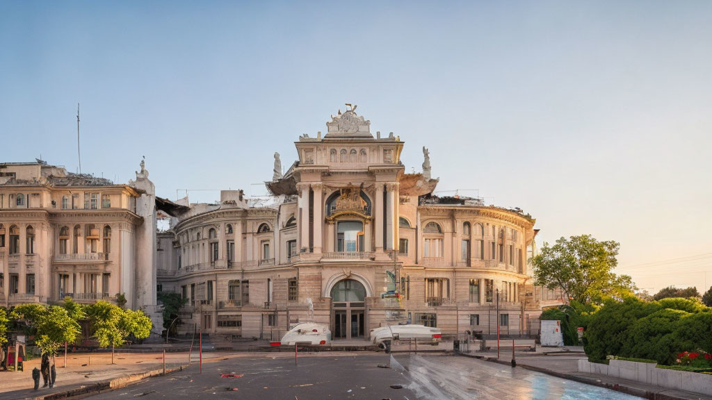 Neoclassical building adorned with sculptures at dusk