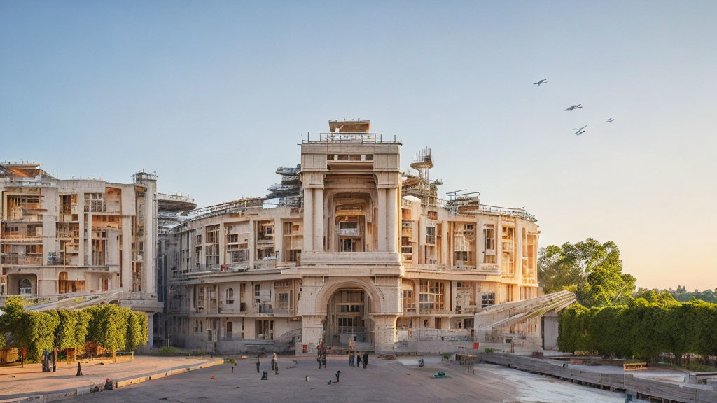 Historic building renovation with scaffolding, people, and birds at dusk