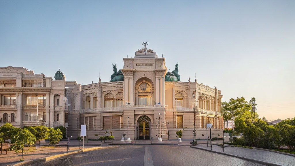 Classical building with central archway and statues in warm light