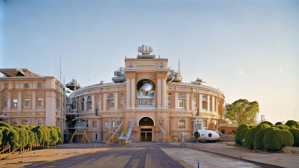 Renovated historic building with scaffolding and unique white pod against clear sky