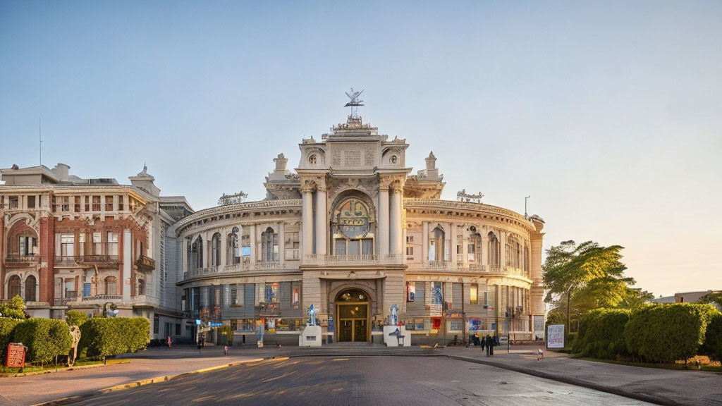 Classical architecture building with sculptures and clock in warm sunlight