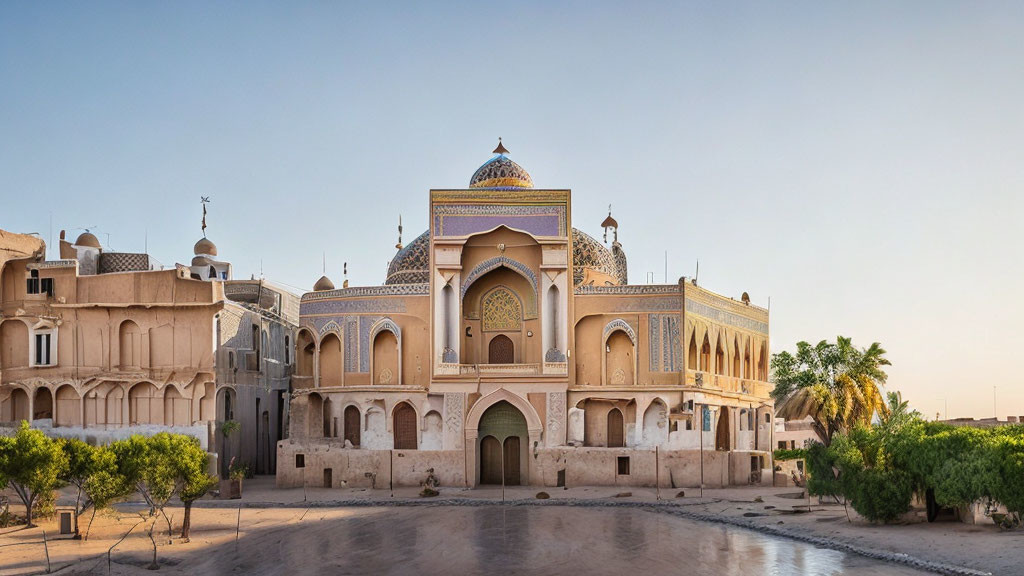 Traditional ornate building with arched entrance and domes against clear sky