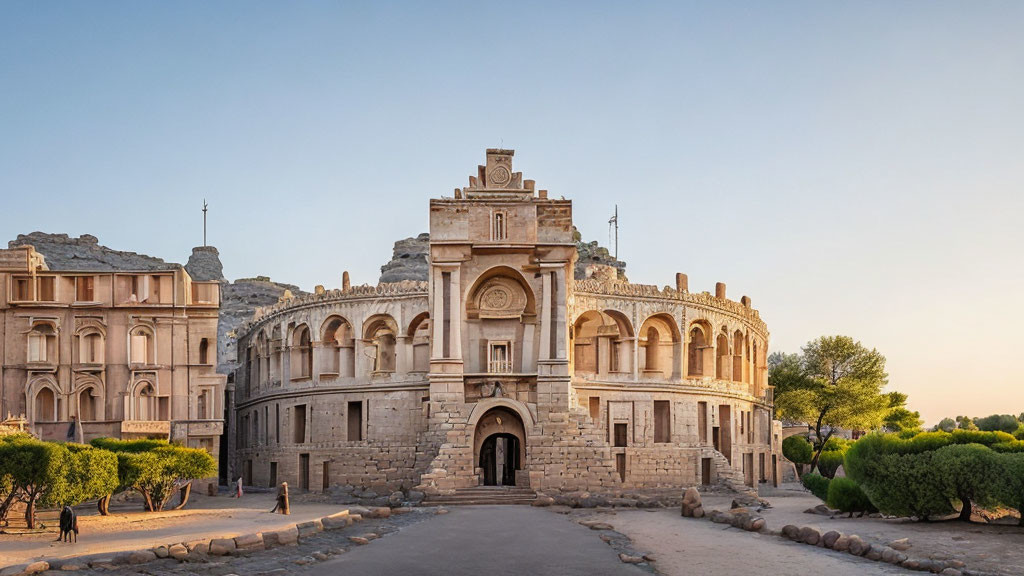 Historical stone building with arches and intricate details in warm sunset light