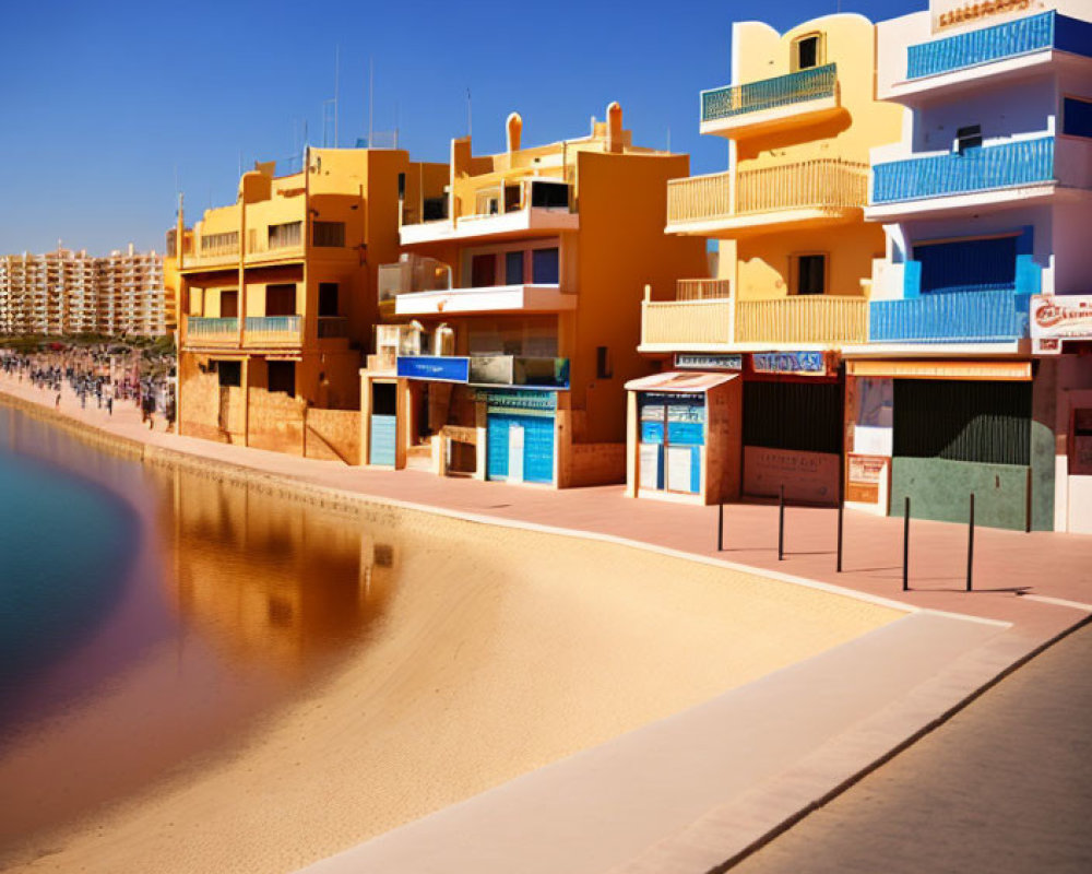 Vibrant beachfront buildings under blue sky on sandy beach.