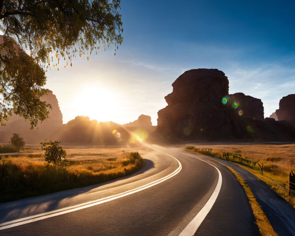 Scenic landscape with winding road and rock formations at sunrise