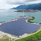 Mountainous Terrain Lake Solar Panels Cloudy Sky