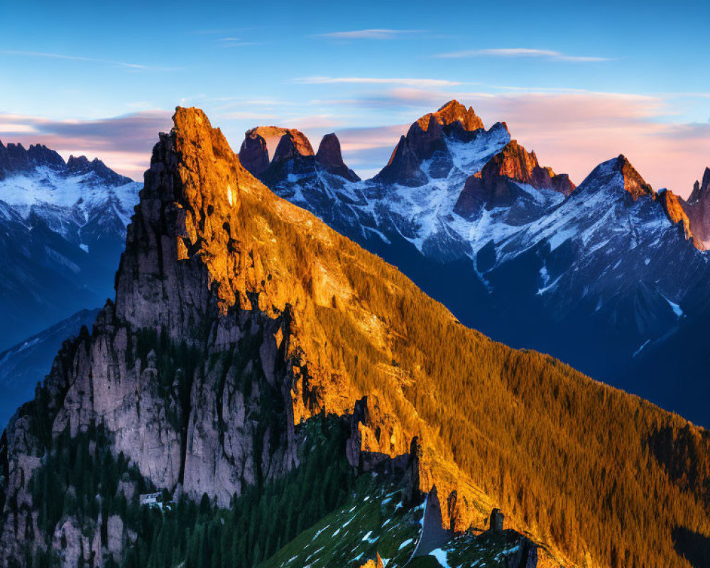 Sunrise illuminates majestic mountain range with warm hues and shadowed valleys