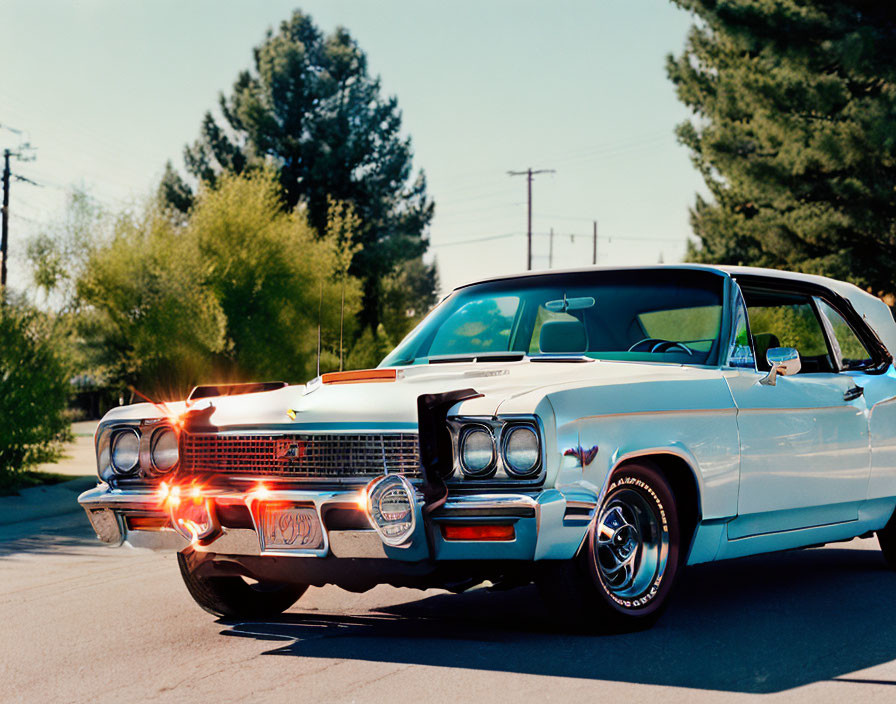 Classic Blue and White Car with Chrome Details Parked on Sunny Suburban Street