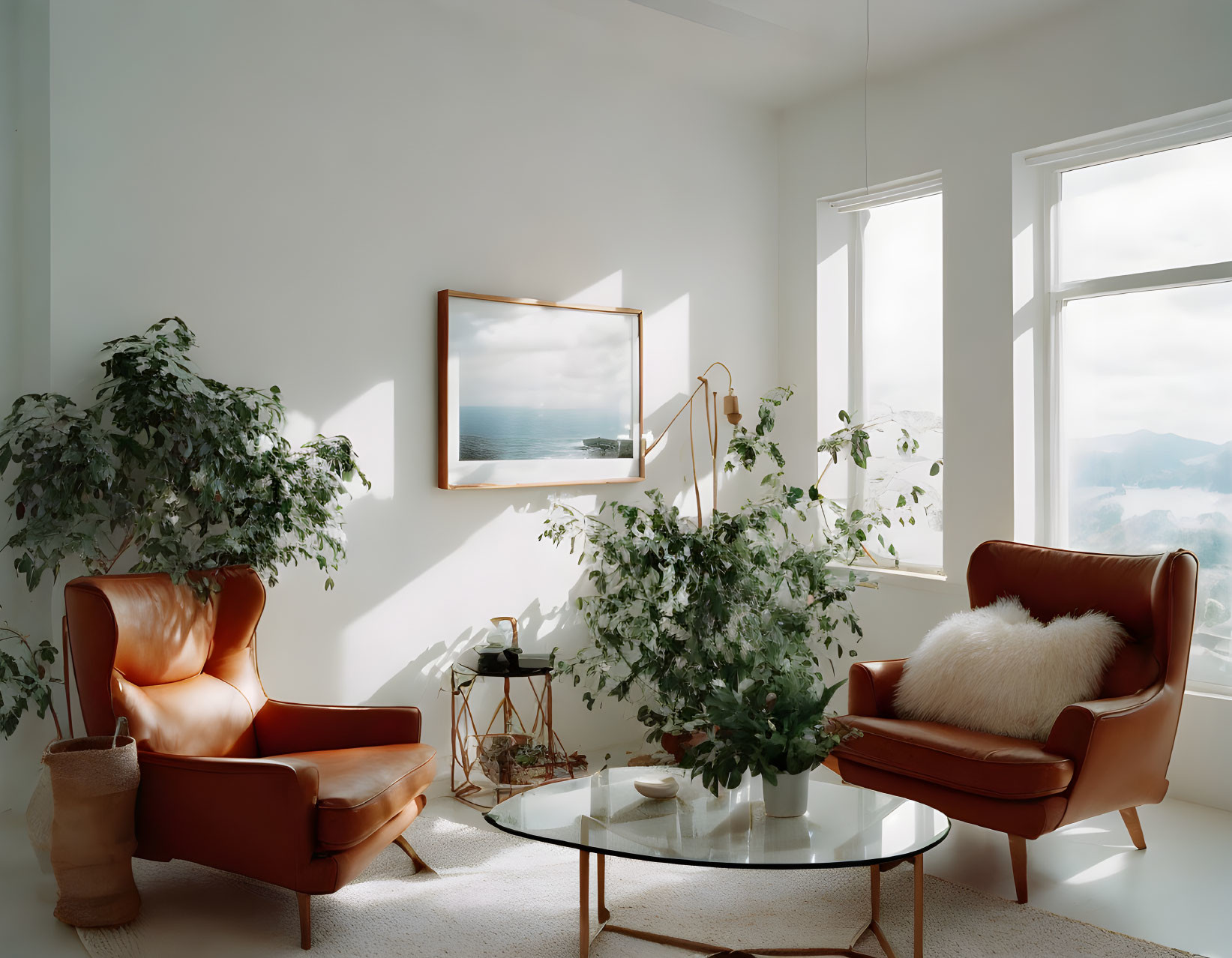 Spacious room with large windows, leather armchair, coffee table, plants, and seascape painting