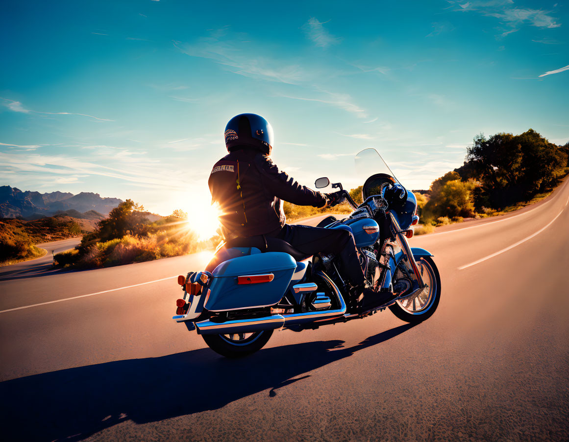 Motorcyclist Riding on Highway at Sunset with Scenic Landscape