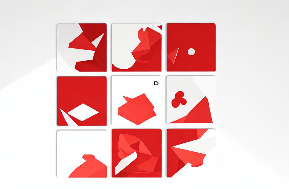Abstract red and white geometric shapes on nine square tiles forming playing card symbols.