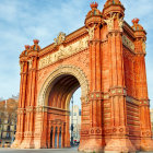 Intricate Orange Archway and Detailed Buildings Against Blue Sky