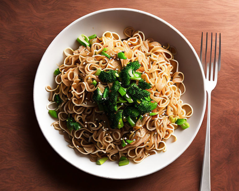 Stir-Fried Noodles with Broccoli and Green Onions on Wooden Table