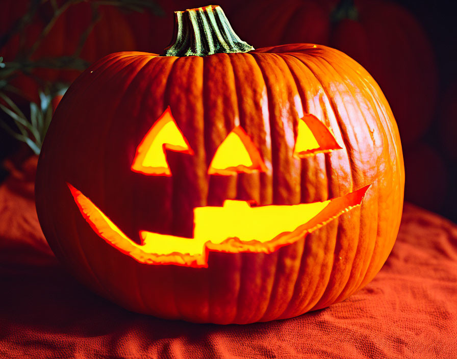 Carved Smiling Jack-o'-Lantern on Red Fabric - Halloween Symbol