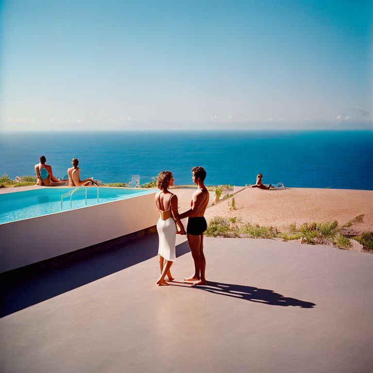Women chatting by infinity pool overlooking ocean, people sunbathing.