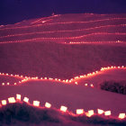 Twilight hillside with red illuminated trails