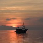 Sunset Seascape with Sailing Ships and UFO in Sky