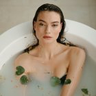 Woman in Milk Bath Surrounded by Roses